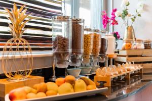 ein Buffet mit Orangen und anderen Speisen auf dem Tisch in der Unterkunft Hôtel Diana Restaurant & Spa by HappyCulture in Molsheim