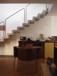 a dining room with a table and a staircase at Arco 37 in Alghero