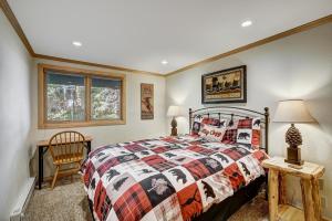 a bedroom with a bed and a table and a chair at Two Bedroom Condo with Parking, Pool, Hot Tub - Steps to Main Street in Breckenridge