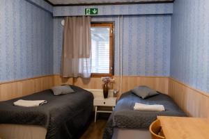 Postel nebo postele na pokoji v ubytování Bed & Breakfast Restaurang Sybarit