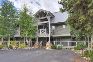 a large house with a driveway in front of it at Two Bedroom Condo with Parking, Pool, Hot Tub - Steps to Main Street in Breckenridge