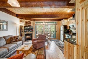 a living room with a couch and a table at Two Bedroom Condo with Parking, Pool, Hot Tub - Steps to Main Street in Breckenridge