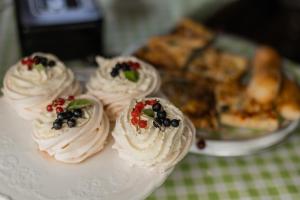 a white plate with four cakes on a table at Niiduveere glämping in Viru-Nigula