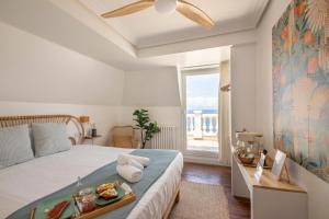 a bedroom with a bed with a tray of food on it at Far Out Inn - Yoga guesthouse in San Sebastián