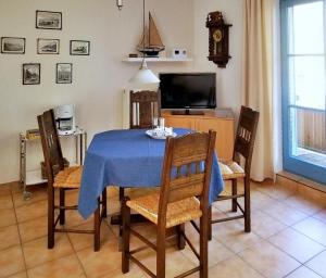 een eetkamer met een blauwe tafel en stoelen bij Blinkfüer am Kap Arkona in Putgarten