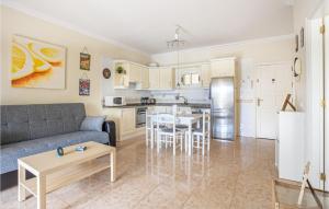 a living room and kitchen with a couch and a table at Awesome Apartment In Puerto De La Cruz in Puerto de la Cruz