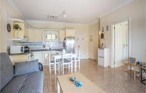 a living room and kitchen with a couch and a table at Awesome Apartment In Puerto De La Cruz in Puerto de la Cruz
