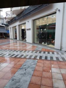 an empty shopping mall with glass windows and tile floors at PlazaVerrosA6Room in Tripoli