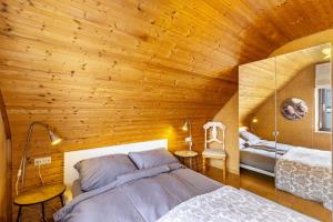 a bedroom with a bed and a wooden ceiling at Ferienwohnung Kalkau in Lichtenstein