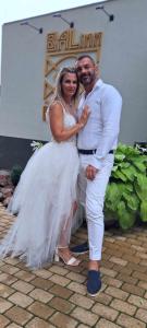 a bride and groom posing for a picture at their wedding at Balinn rooms in Balatonszepezd