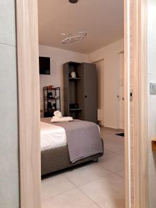 a bedroom with a bed in a room with a mirror at Sikelia Superior Rooms Milazzo in Milazzo