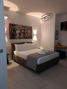 a bedroom with a large bed in a room at Sikelia Superior Rooms Milazzo in Milazzo