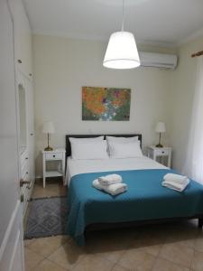 a bedroom with a bed with two towels on it at Sunny stay furnished apartment in Kanoni in Kanoni