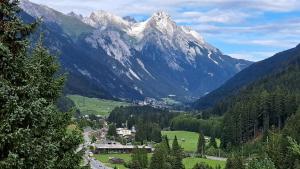 a view of a valley with a snow covered mountain at Apart Wolfgang Birkl in Sankt Anton am Arlberg