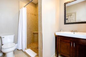 a bathroom with a toilet and a sink and a shower at Wellington Street Inn by Hoco Hotels Collection in Stratford