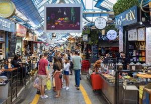 a crowd of people walking through a market in a store at One bedroom Machane Yehuda Design Apartment in Jerusalem