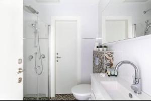 a bathroom with a toilet and a sink and a shower at One bedroom Machane Yehuda Design Apartment in Jerusalem