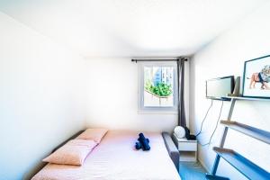 a bedroom with a bed and a window at Le petit Chinard- studio cosy-Vaise in Lyon