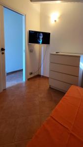 a living room with a flat screen tv on the wall at VILLA BIFAMILIARE SCOPELLO in Scopello
