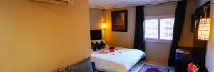 Postel nebo postele na pokoji v ubytování Palais Riad Reda & Spa