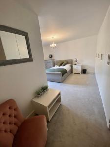 a living room with a bed and a couch at The Wimbledon Apartment in Raynes Park