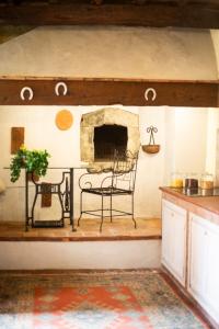 a room with a table and a chair and a fireplace at Agriturismo Tassinaia in Pontassieve