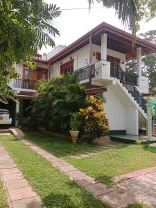 una casa con una escalera delante de ella en Home Stay Resort en Nilaveli