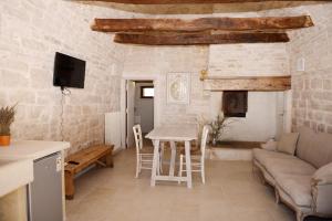 a living room with a table and a couch at Masseria Signora in Martina Franca