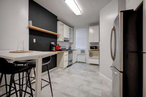 a kitchen with a counter and a refrigerator at Get Spoiled in this Urban 1BR 15min to NYC in Hoboken