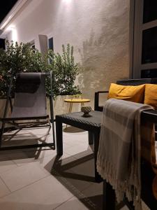 a living room with a couch and a chair at Sikelia Superior Rooms Milazzo in Milazzo