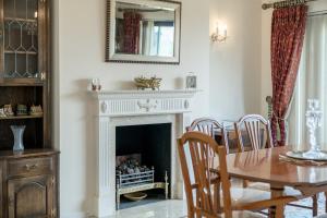 a dining room with a table and a fireplace at Vintage Boutique 2Bed Apartment in Whetstone