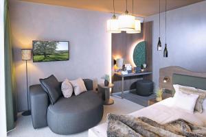 ein Schlafzimmer mit einem Bett, einer Couch und einem Schreibtisch in der Unterkunft Schwarzwald Panorama in Bad Herrenalb + 37 Fotos