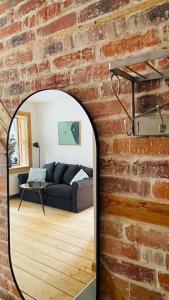 a living room with a brick wall and a mirror at U Babci Marysi in Karpacz