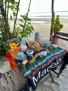 a picnic table with a meal on the beach at Sunsand Beach Suítes e Hostel in Camocim