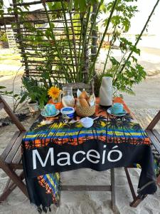 a table with a maggio table cloth on it at Sunsand Beach Suítes e Hostel in Camocim