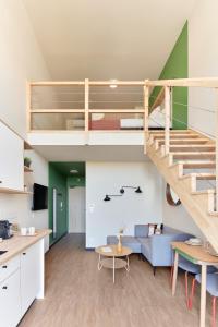a loft apartment with a staircase and a living room at Hife Toulouse Labège in Labège