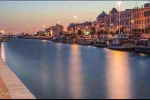 a view of a river with boats in a city at Civico 22 in Fiumicino