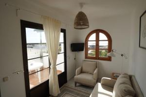 a living room with a couch and a window at El Caleton Sea View Apartment in El Cotillo