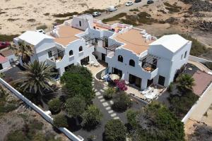 an aerial view of a large white house at El Caleton Sea View Apartment in Cotillo