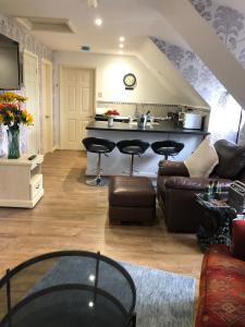 a living room with a couch and a kitchen at Margaret's Manor in Birchington