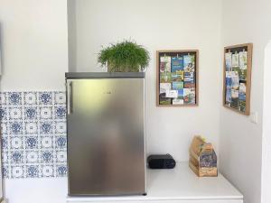 a silver refrigerator with a plant on top of it at Ferienwohnung Lusenhöh in Mauth