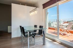 a dining room with a glass table and chairs and a balcony at S2SEP498 - Great apartment with private terrace in Barcelona