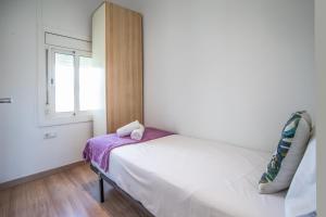 a small bedroom with a bed and a window at S2SEP498 - Great apartment with private terrace in Barcelona