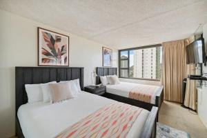 une chambre d'hôtel avec deux lits et une grande fenêtre dans l'établissement Tower 1 Suite 2705 - QQS, à Honolulu