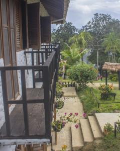 a stairway leading up to a house with flowers at Waira Selva Hotel in Puerto Nari&ntilde;o