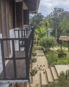a stairway leading up to a house with flowers at Waira Selva Hotel in Puerto Nariño