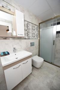 a bathroom with a toilet and a sink and a shower at Villa Manzara in Selcuk