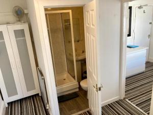 a bathroom with a shower and a toilet and a sink at The Hotel Blackpool in Blackpool