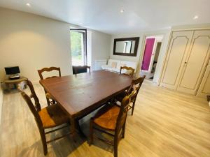 a dining room with a wooden table and chairs at Les Moulins Du Duc ÉCOLODGE in Moëlan-sur-Mer