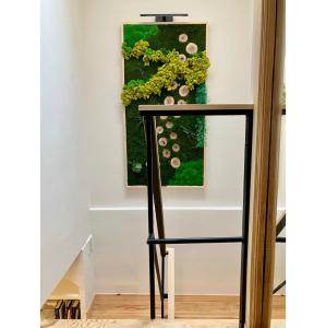 a black chair in front of a painting on a wall at Casa del Concejo in Segovia